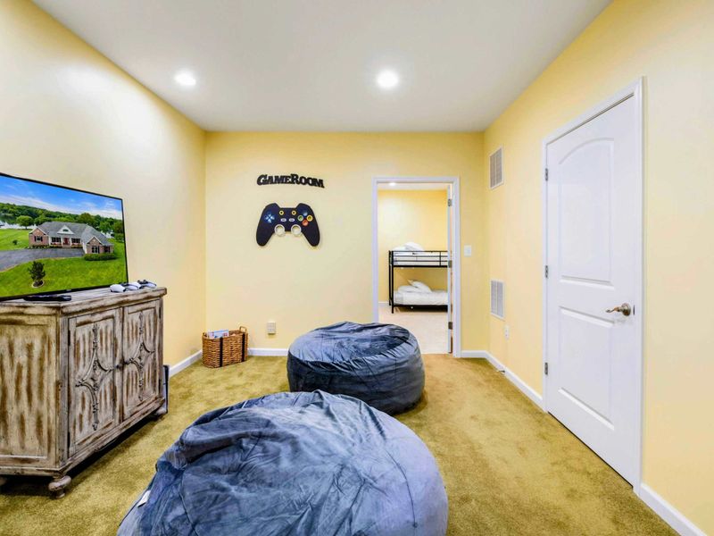 Bean Bag Lounge - Another angle showing the bean bags, TV console, and the bunk room visible through the doorway.