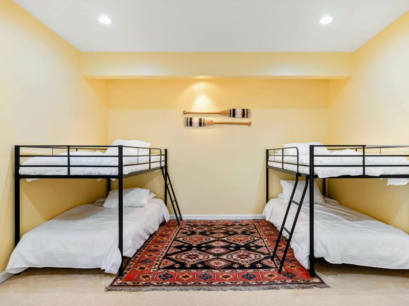 Bunk Room - Two sets of bunks face each other with oar decor overhead, turning bedtime into part of the lake house adventure.
