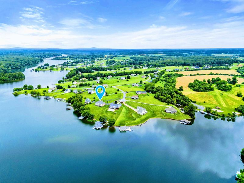 Peninsula Living - A wide aerial reveals the point location, with water wrapping around the neighbourhood on multiple sides.