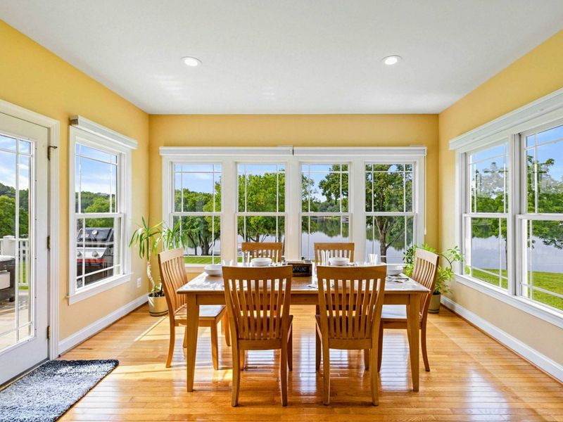 Dining Nook - Windows on three sides wrap this eat-in space in natural light with views of the lake through the trees.