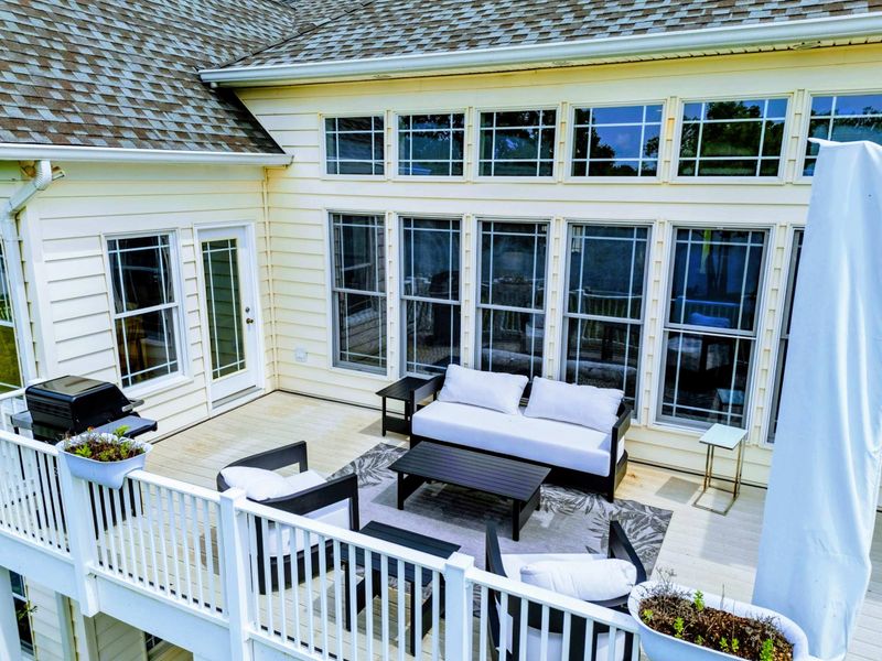 Deck Seating - Cushioned outdoor furniture and a gas grill make the upper deck a go-to spot for meals and relaxation.
