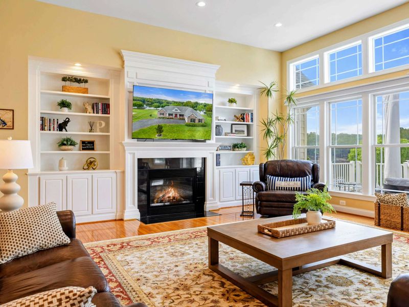 Great Room Fireplace - Built-in bookshelves flank the stone fireplace and Smart TV, the anchor of this inviting living space.