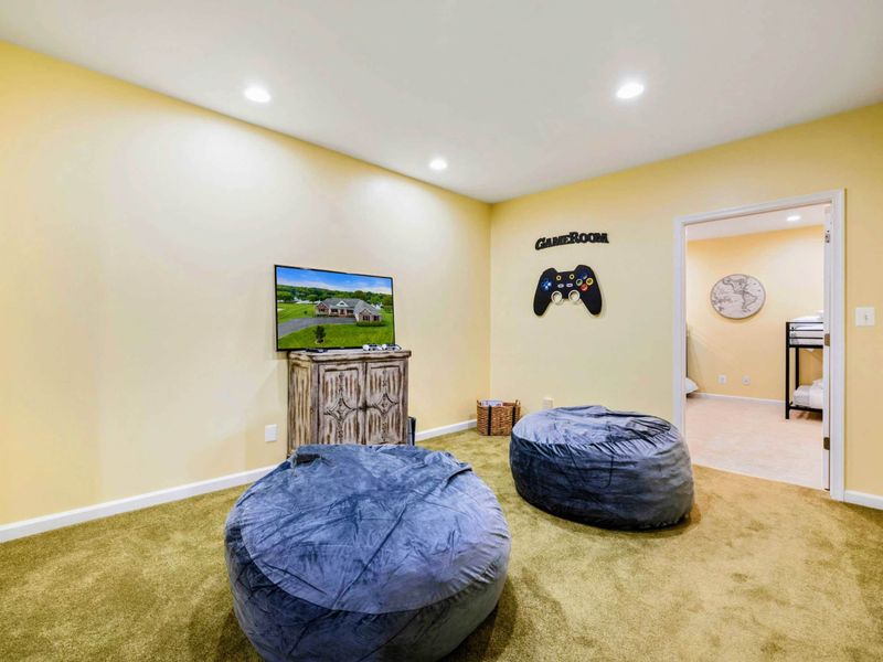 Bean Bag Lounge - Oversized bean bags, a Smart TV, and a "Game Room" sign create a laid-back space for kids and teens to hang out.