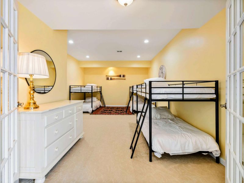 Bunk Room - Three sets of twin-over-full bunk beds, an oriental rug, and decorative oars on the wall make this the favorite room for younger guests.