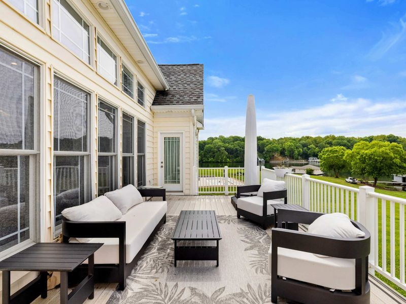 Deck Overview - The spacious furnished deck wraps around the home with views to the yard and lake from every seat.