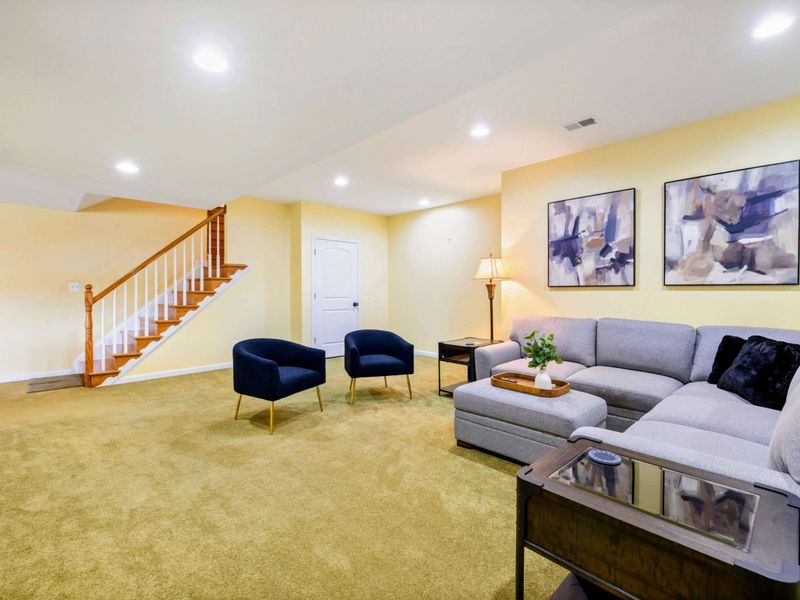 Game Room - The staircase, seating area, and Smart TV give this lower-level space a relaxed, second-living-room feel.