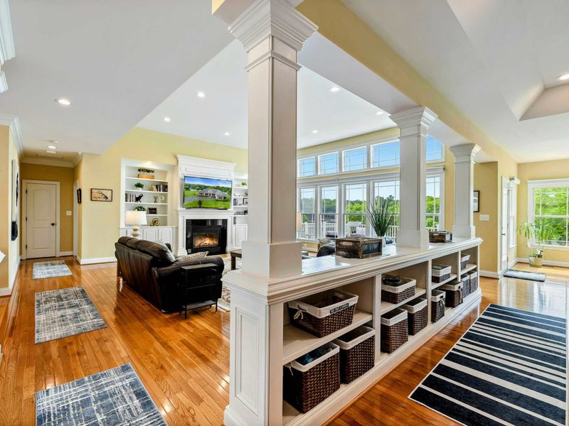 Open Layout - The half-wall with built-in storage separates the living and dining areas while keeping the space feeling open and connected.