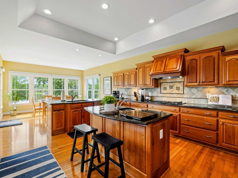Kitchen Overview - Natural light pours in from the windows as the kitchen flows into the dining nook and living areas.