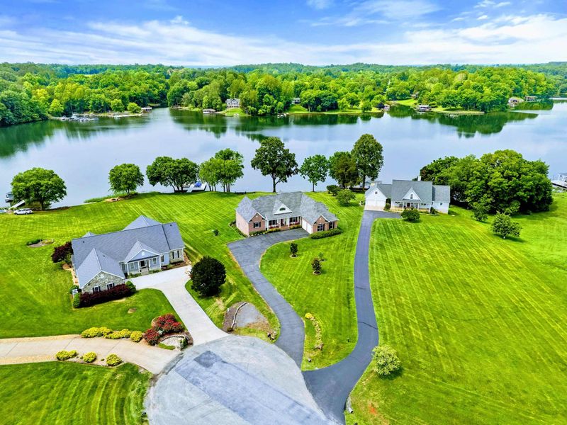 Neighbourhood Setting - A higher perspective shows the home nestled in a quiet lakeside community with water on all sides.