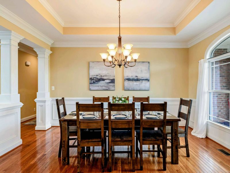 Formal Dining - Wainscoting, tray ceiling, and a chandelier set the tone for special dinners and holiday gatherings.