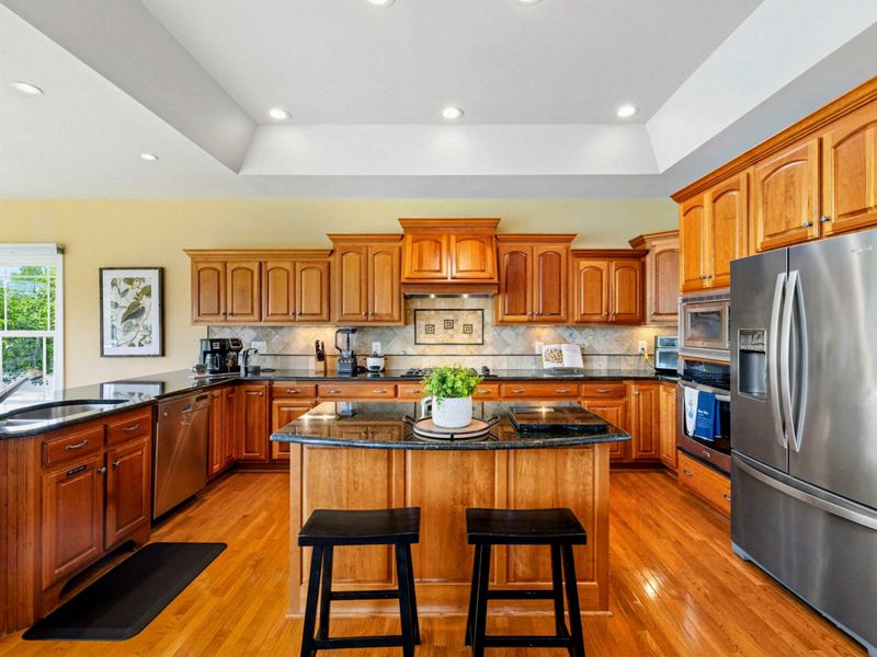 Kitchen Wide View - The full kitchen with tray ceiling, center island, and plenty of counter space for preparing meals together.