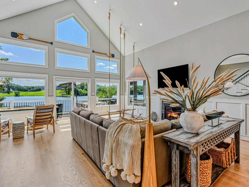 Great Room - Vaulted ceilings and a wall of windows pull the lake into the heart of the home, where the whole crew naturally gathers.