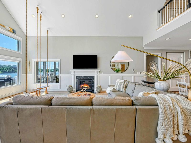 Living Room - An open sectional layout keeps everyone connected, with the lake always in view through the wall of windows.