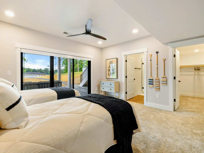 Bedroom 3 - Lake-themed decor, a walk-in closet, and paddle accents give this two-queen room a playful lakehouse feel.