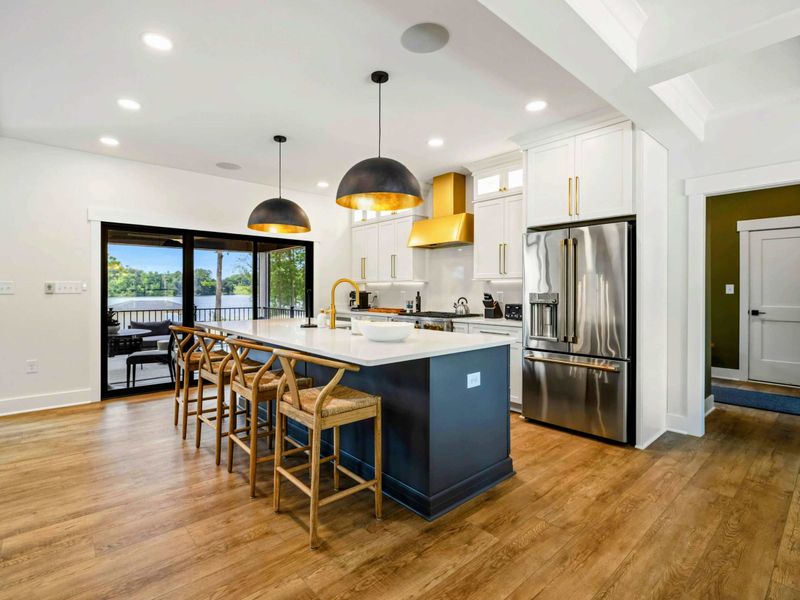 Kitchen - Sliding glass doors open to the screened porch, keeping the lake breeze close while you cook.
