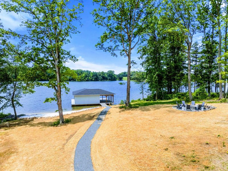 Backyard - Dock, beach, or fire pit: the full lakefront spread is visible from the private grounds.