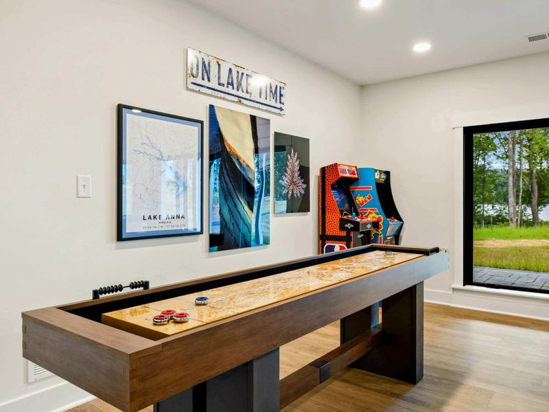 Game Room - Lake Anna art, an "On Lake Time" sign, and a professional shuffleboard table set the tone for friendly competition.