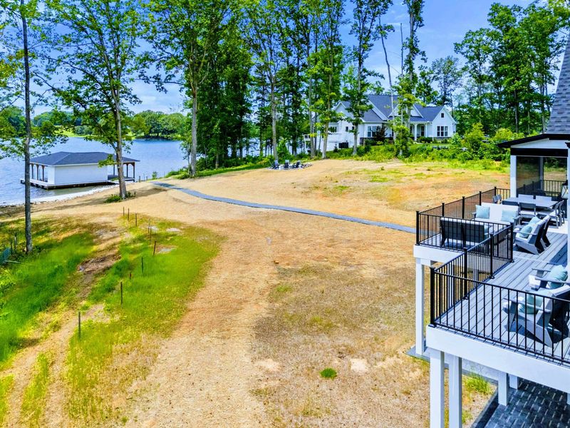 Deck - Refined deck spaces and a private shoreline create an effortless lakefront rhythm across multiple levels.