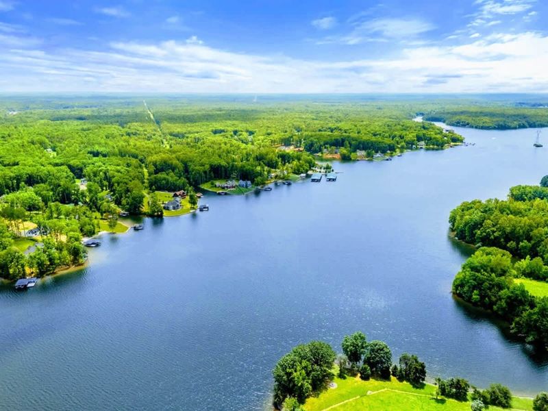 Aerial View - A wide vista of Lake Anna's Private Side, where calm waters and green shoreline stretch to the horizon.