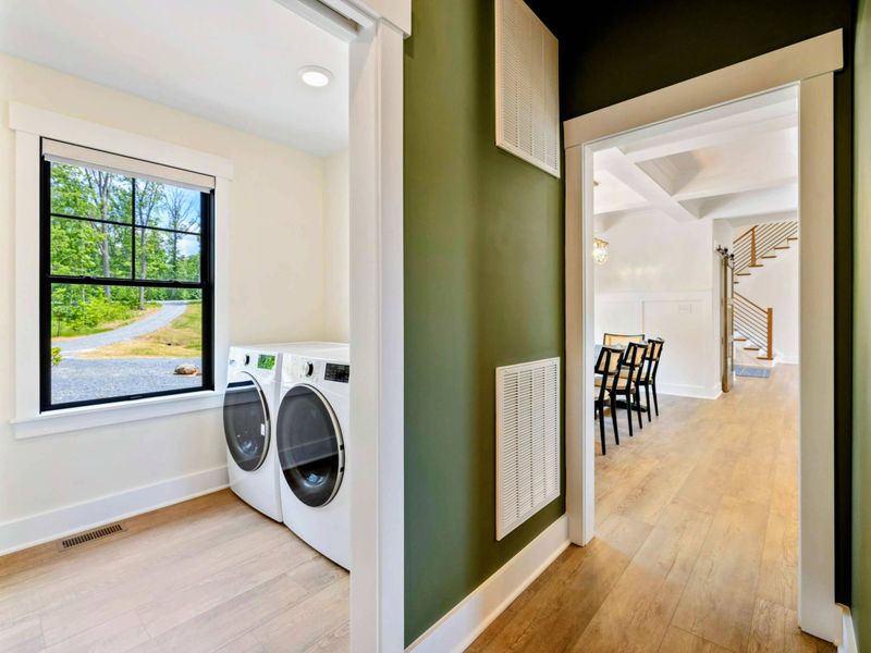 Laundry Room - A full-size washer and dryer sit in a dedicated room with a window, conveniently located off the main hallway.