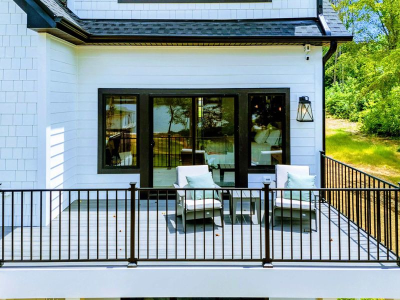 Foyer - A thoughtfully designed entry with a loft railing above and an open floor plan ahead.