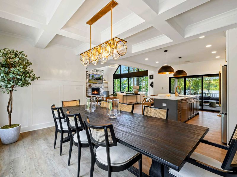 Dining Room - The coffered ceiling, wainscoting, and elegant chandelier create a polished space for group dinners.