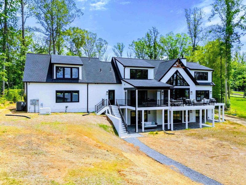 Exterior - Tucked into the trees, the modern farmhouse feels peaceful, private, and beautifully unhurried.