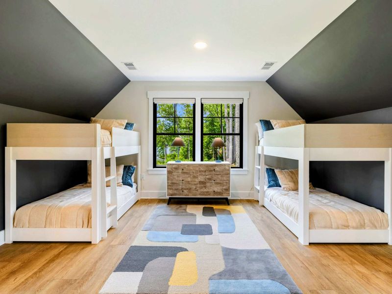 Bunk Room - Two sets of twin-over-twin bunks with a colorful geometric rug sleep four in this charming upper-level room.