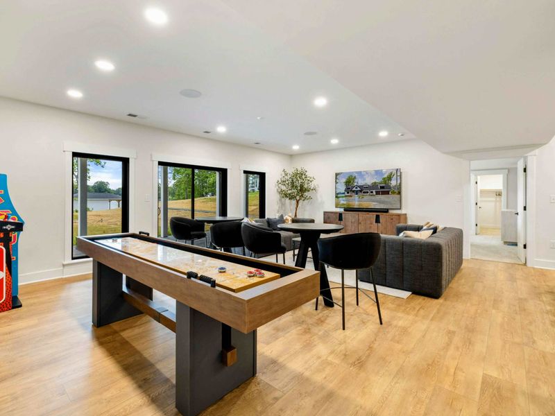 Game Room - A full-size shuffleboard table, NBA Jam arcade cabinet, and lounge seating make this a favorite gathering spot.