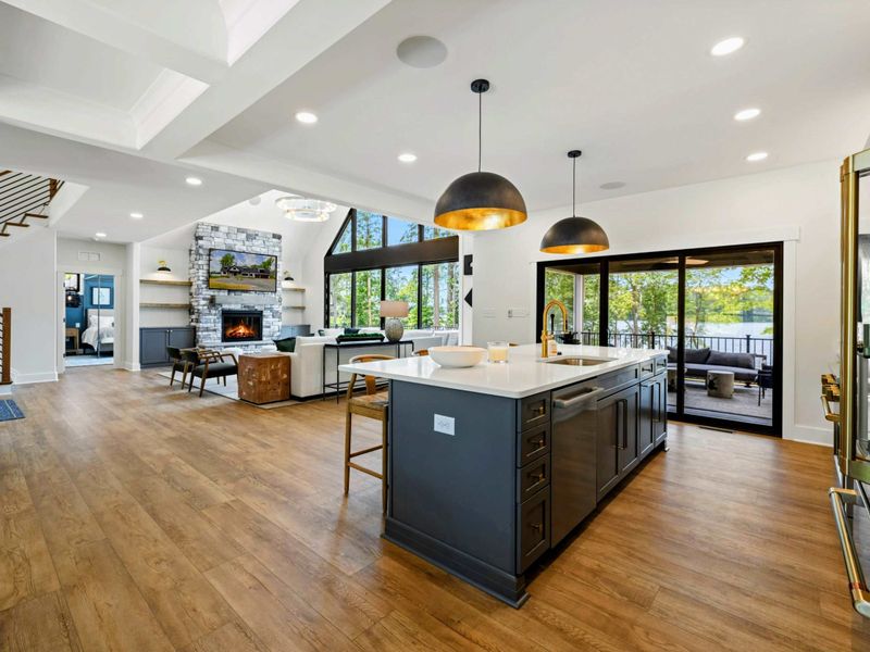 Kitchen - The expansive open-concept layout ties together the cooking, dining, and living spaces with lake views in every direction.