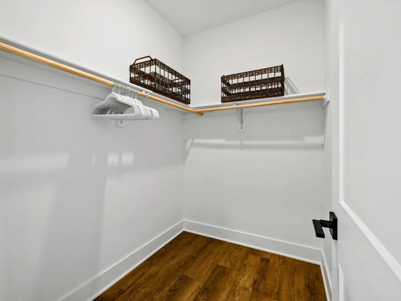 Primary Closet - A spacious walk-in closet with ample hanging space and storage baskets keeps everything organized.