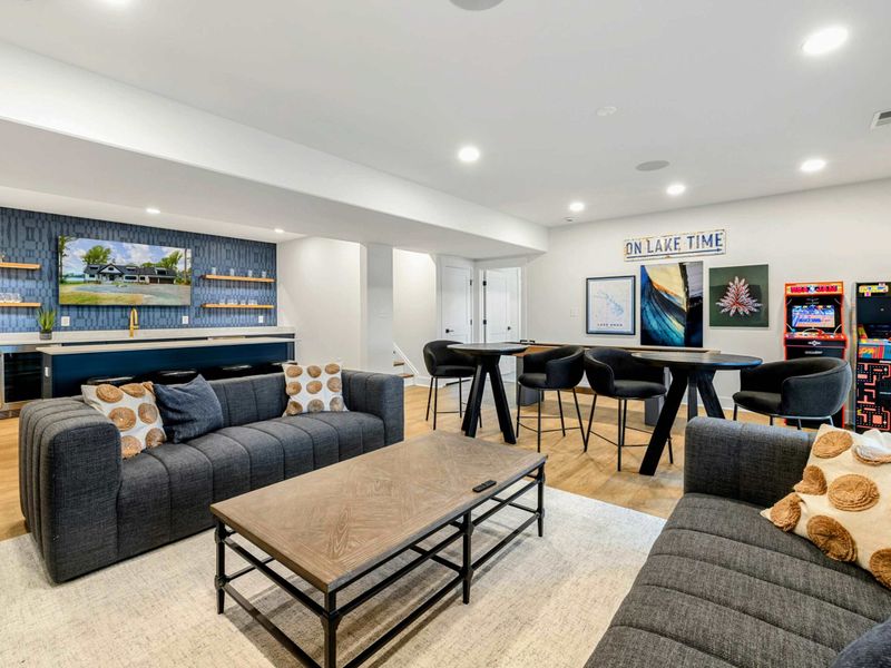 Game Room Lounge - The full entertainment level includes shuffleboard, arcades, lounge seating, and a wet bar with lake views.