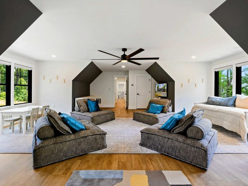 Bunk Room Loft - The full layout includes built-in bunks, lounge seating, a TV area, and a kids' craft table by the windows.