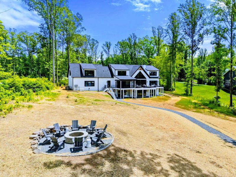 Fire Pit - A refined outdoor circle with Adirondack chairs that makes hosting feel easy, natural, and warm.