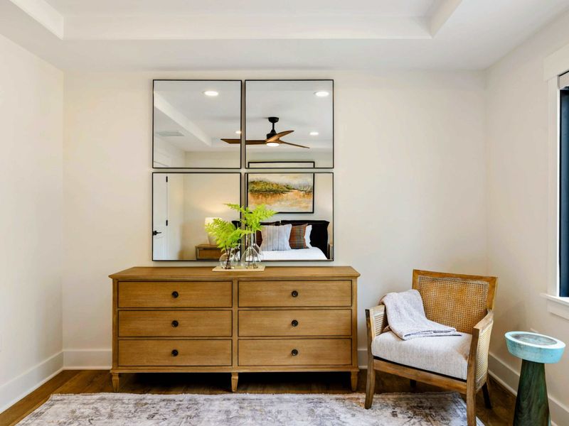 Bedroom 6 - A dresser with a four-panel mirror and a cane-back reading chair create a thoughtful sitting area in this upper suite.
