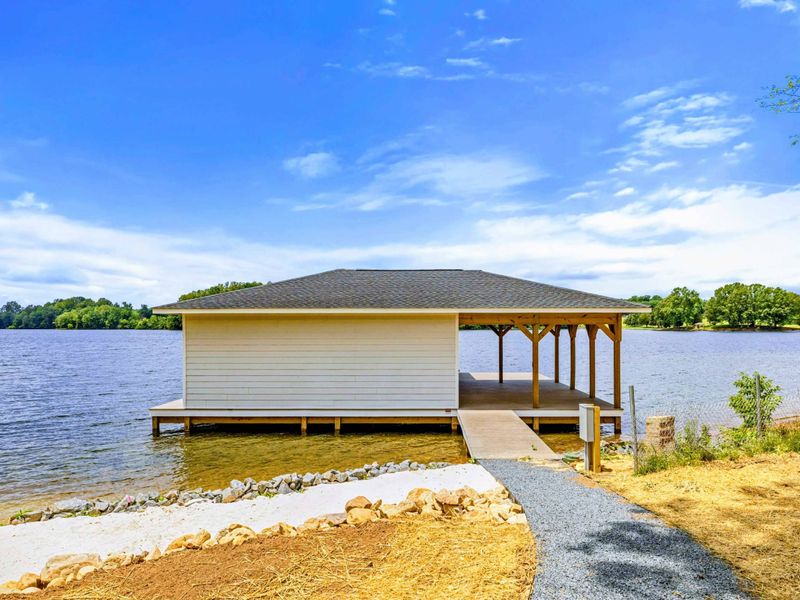 Backyard - Follow the gravel path down to shade, shoreline calm, and open-water views just steps from the house.