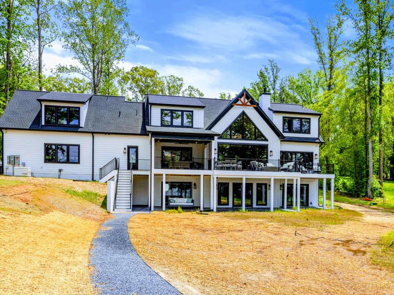 Exterior - Refined modern farmhouse design with generous outdoor living spaces, made for relaxed lakefront gatherings.