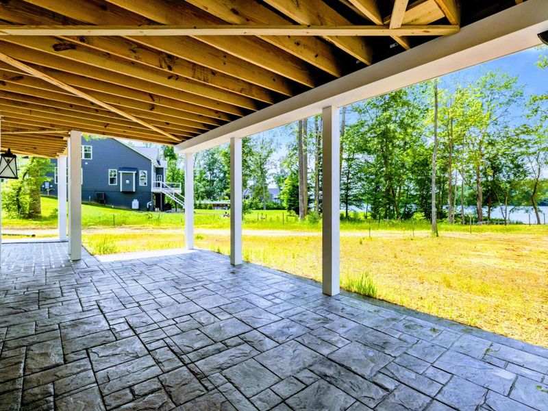 Deck - A quiet covered spot to slow down with a breeze and a glimpse of the lake beyond.