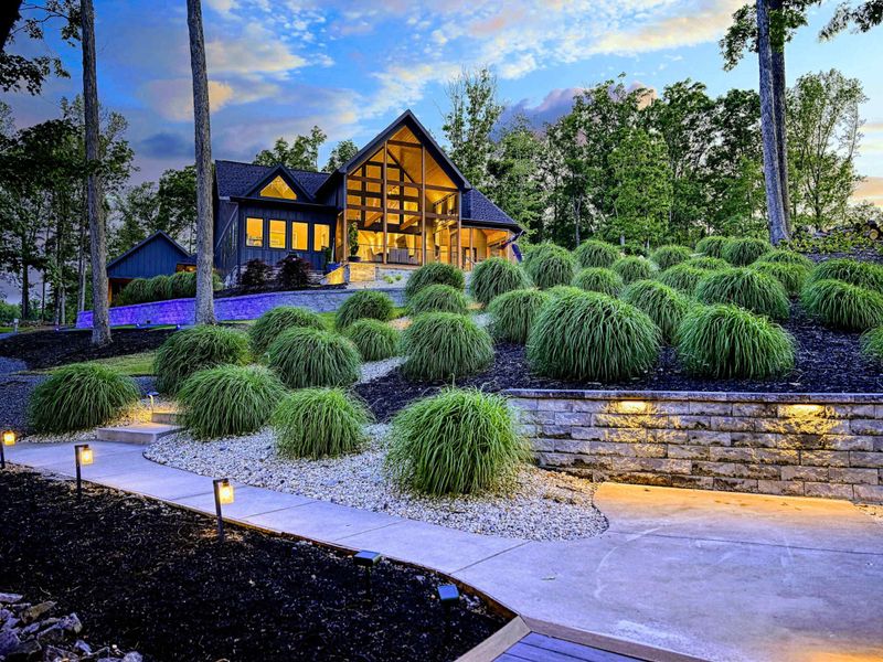 Landscaped Walkway - Ornamental grasses and LED-lit steps lead from the lakefront path up to the home, creating a resort-like arrival experience.