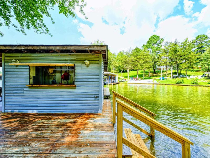 Dock - Storage shed and wood railing at the water's edge with dock access.