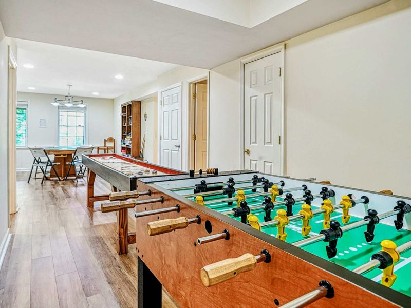 Game Room - Wide view of the foosball table, shuffleboard, and poker area for hours of group entertainment.
