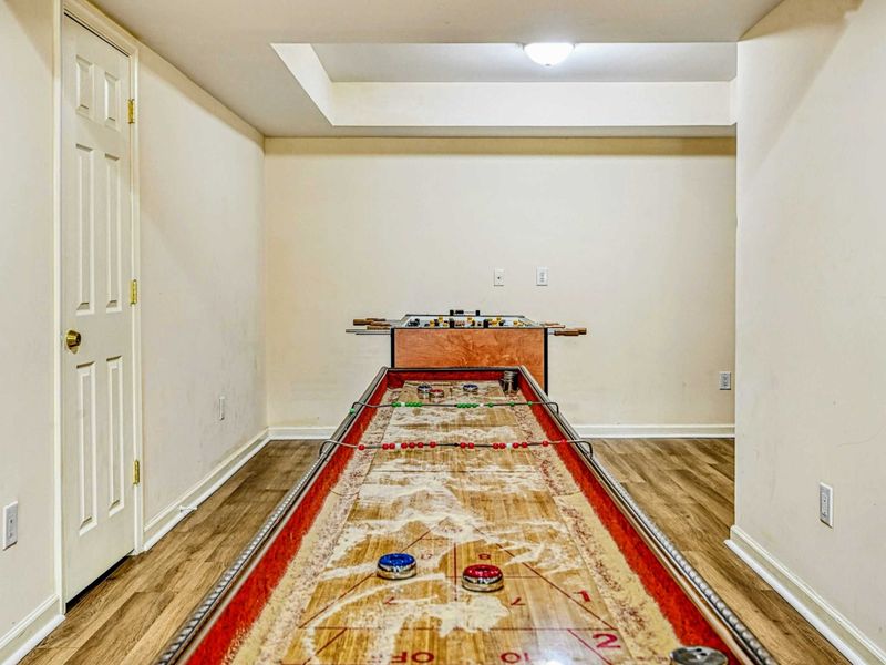 Game Room - Full-length shuffleboard table for competitive fun on the lower level.