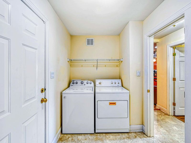 Laundry Room - Full-size washer and dryer with wire shelf above for guest convenience.
