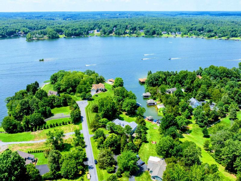 Aerial - Wide Lake Anna view with boats on the water and the lush summer neighborhood below.