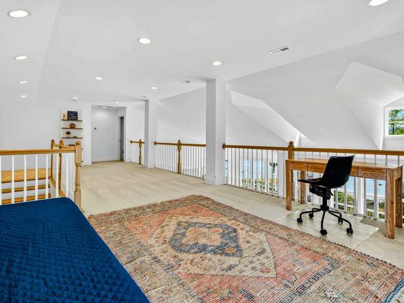 Loft Office - The open loft extends from the sleeping area to a desk nook with sweeping views down into the great room.