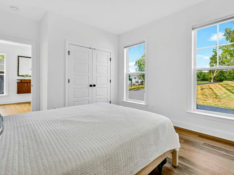 Guest Bedroom - White quilted bedding, dual windows, and natural light create a calm, breezy retreat.