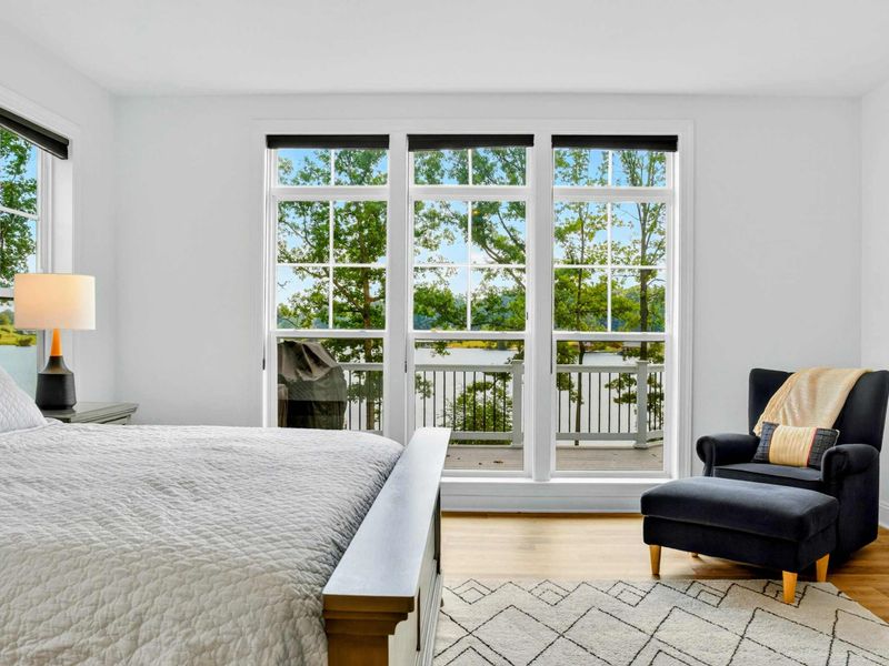 Primary Suite Balcony - French doors open from the king bed straight onto a private balcony with treetop lake views.