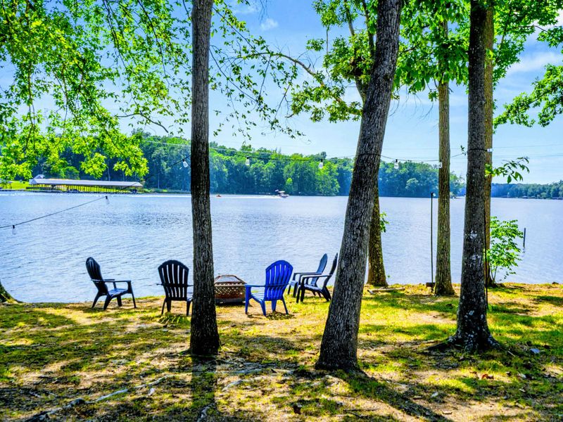 Lakeside Seating - Chairs and a fire pit tucked beneath the trees along the shore, perfect for golden-hour drinks before dinner.