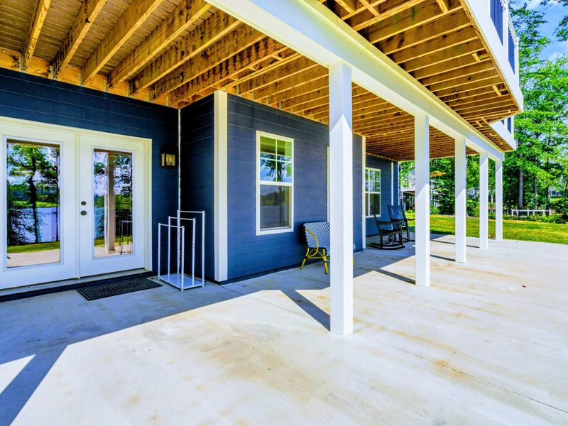 Porch Entry - French doors open from the lower-level family room straight onto the covered porch, blending indoor and outdoor living.