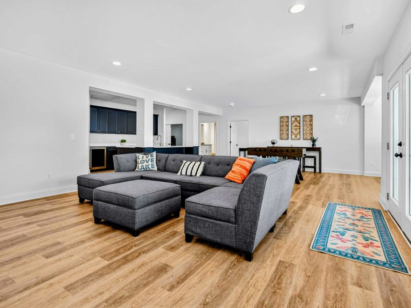 Family Room - The spacious lower level offers a second living area with sectional, ottoman, and a Live Love Lake pillow for good measure.